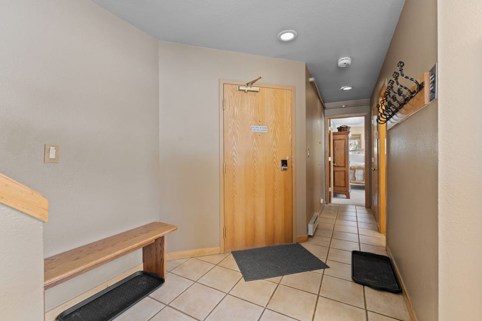 Entryway with a bench and hooks.