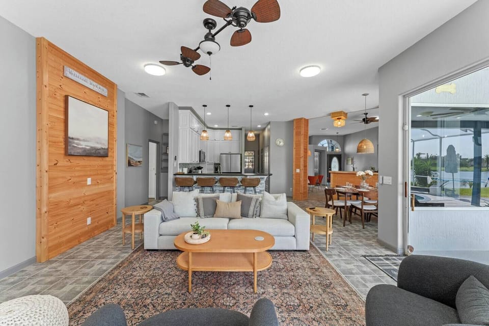 Bright open concept living  With fireplace and pool views