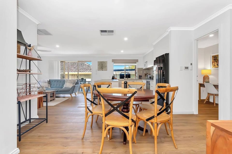 Gather around the dining table for easy meals and shared moments after a day exploring nearby walking trails.