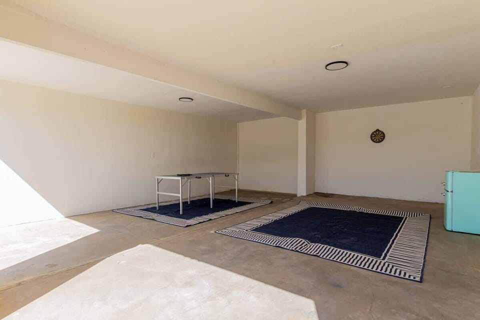 Recreation area with ping pong table, dart board and corn hole