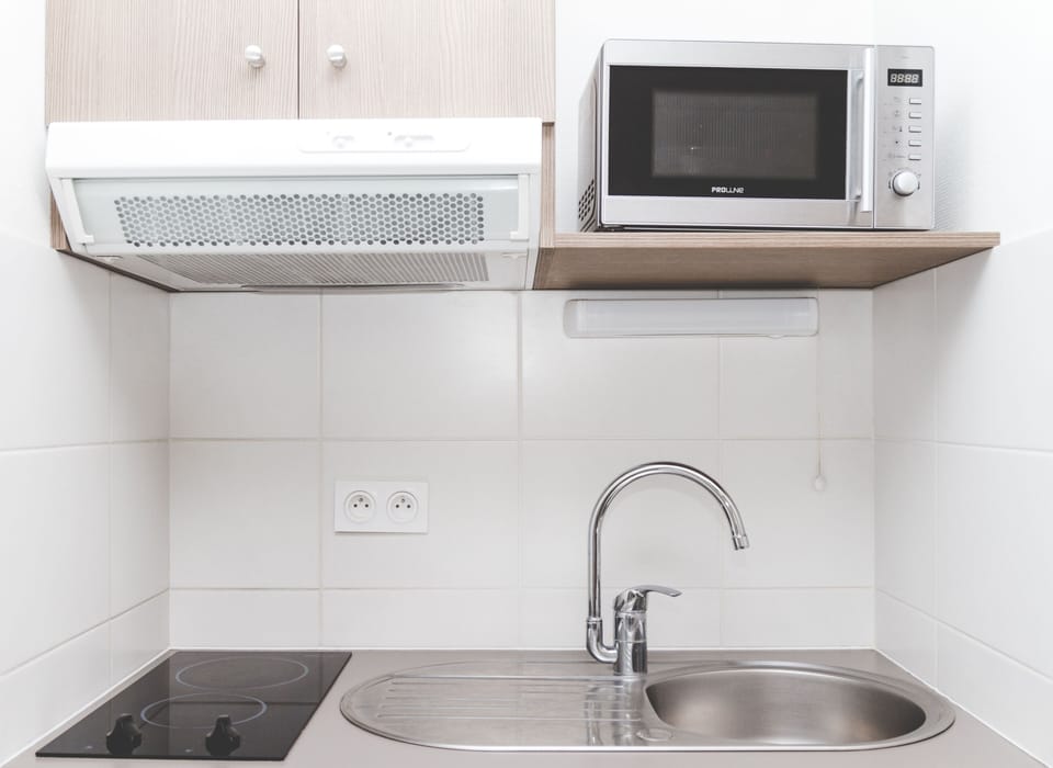 The kitchenette is fully equipped with modern appliances for easy breakfasts and simple home-cooked meals.