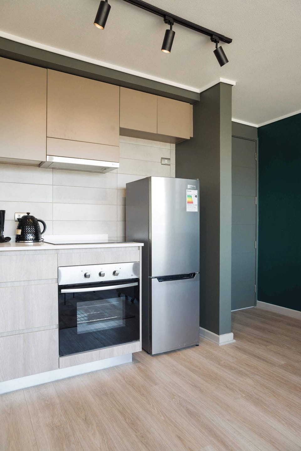 Sleek and modern kitchen with stainless steel appliances and stylish accents, perfect for culinary adventures.