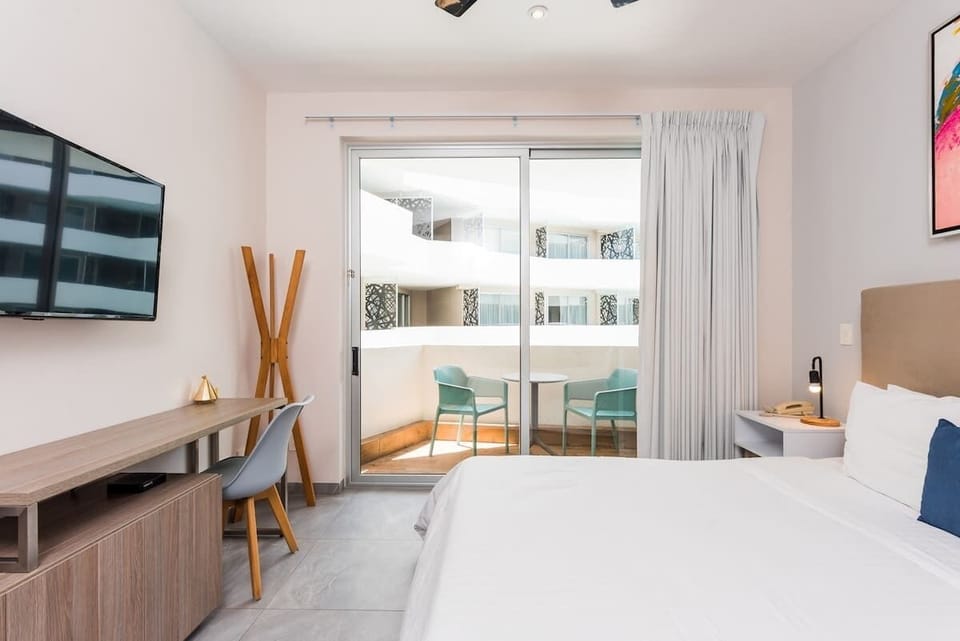 High-definition TV, ceiling fan, workspace, AC, plenty of light, and a spacious balcony
