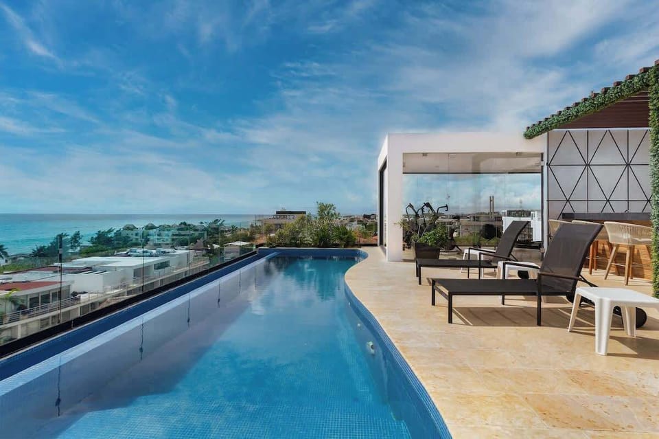 Take a dip in our infinity pool! Ocean views & comfy loungers await.