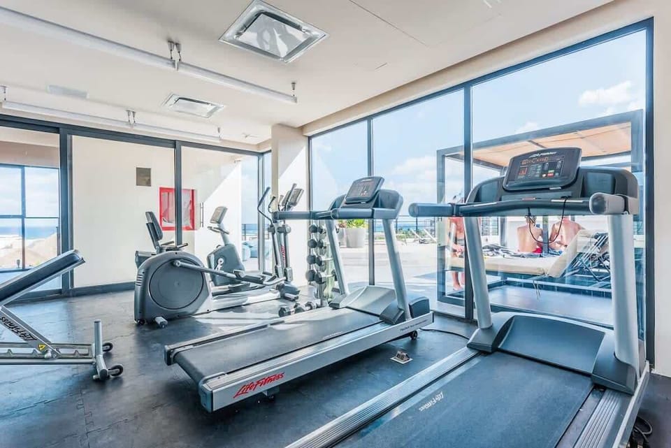 Modern gym. Stay fit with ocean views during your vacation.