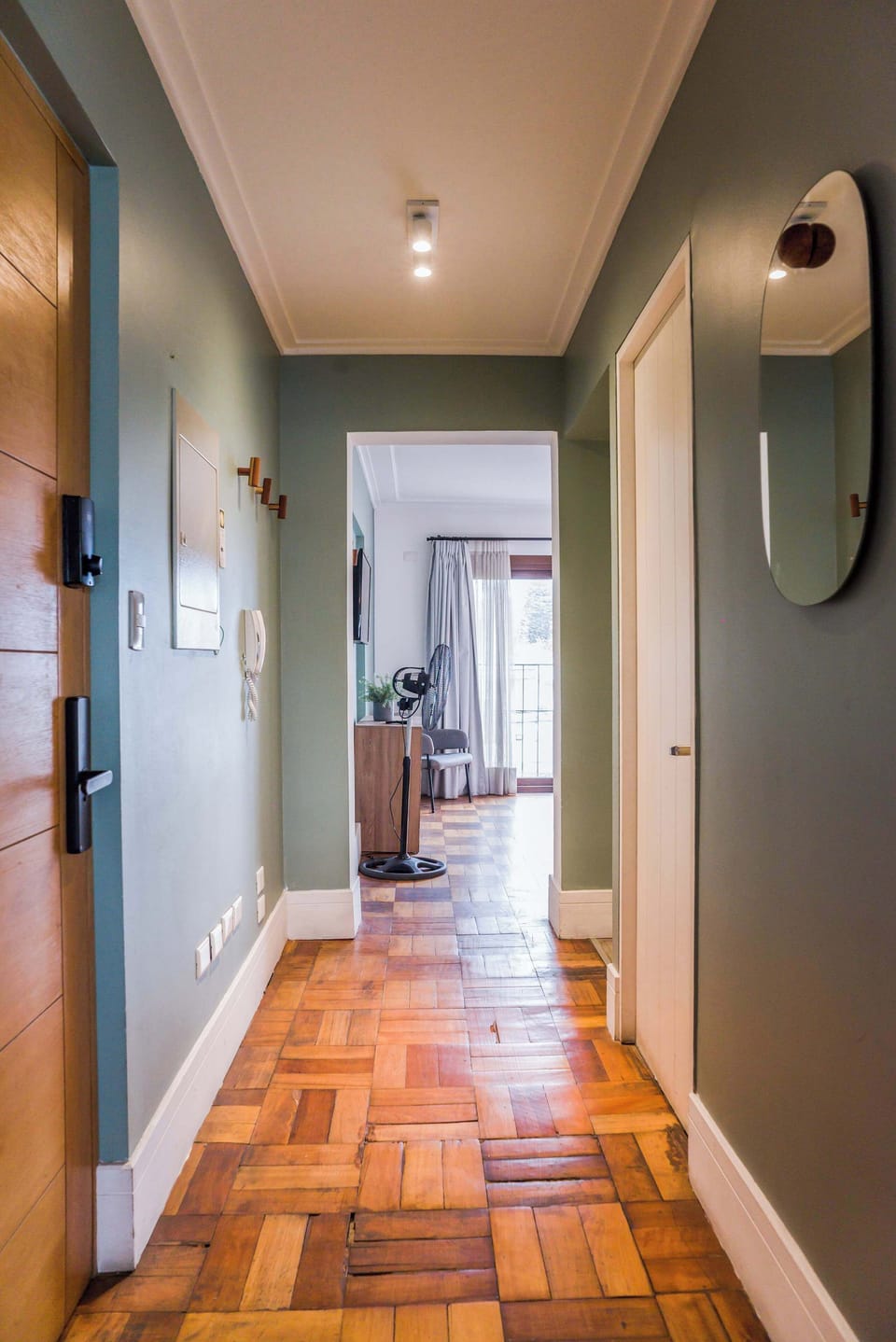Inviting hallway leading to a cozy living space with natural light and stylish decor.