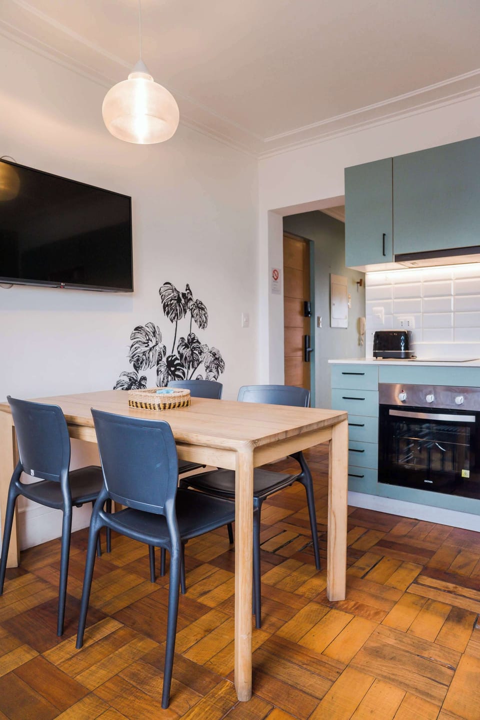 Cozy dining area with modern kitchen and stylish decor, perfect for intimate meals.