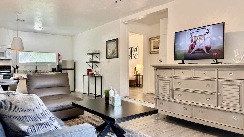 Living room — smart TV, opens to kitchen and bedroom.