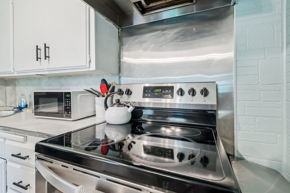 Modern stovetop and cooking area with essential appliances for easy meal prep.
