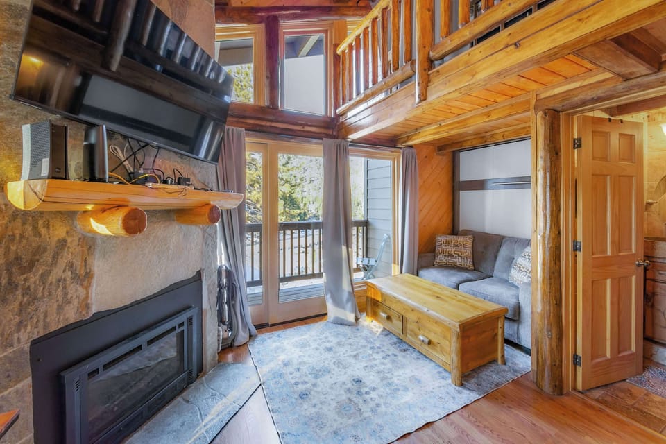 Living space with murphy bed, balcony, and Smart TV