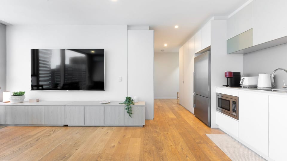 Open living area with large TV and sleek finishes
