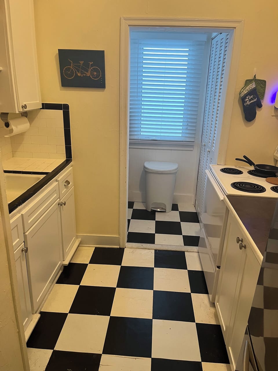 Kitchen with stove, toaster oven , coffee machine , microwave and fridge.