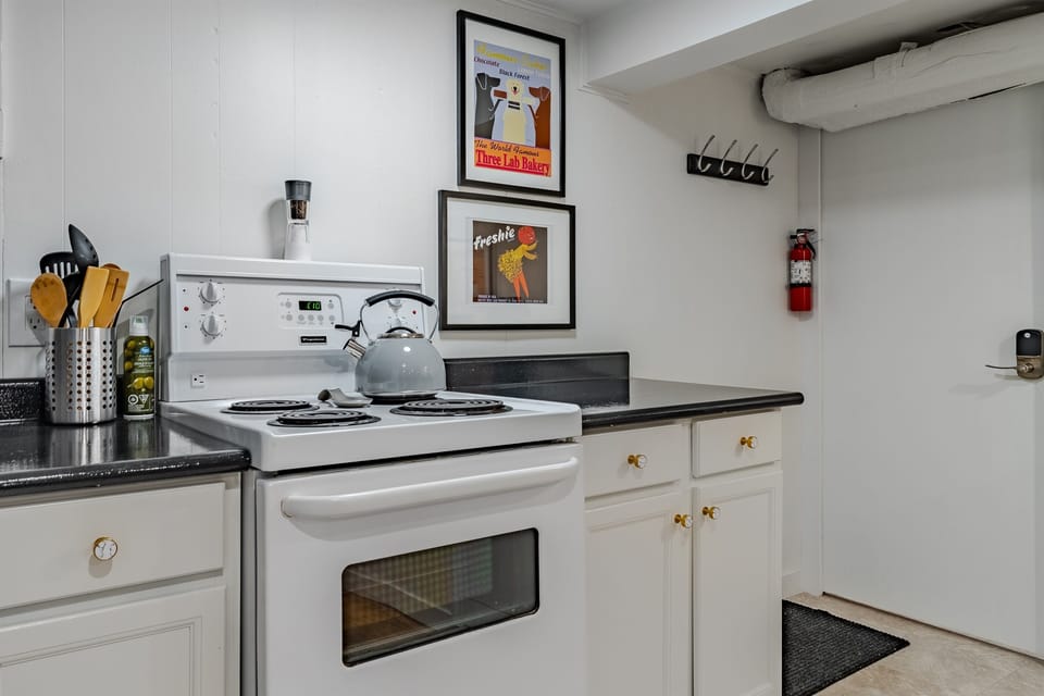 Basic cooking setup with stove, cookware, and dishware for simple meals.