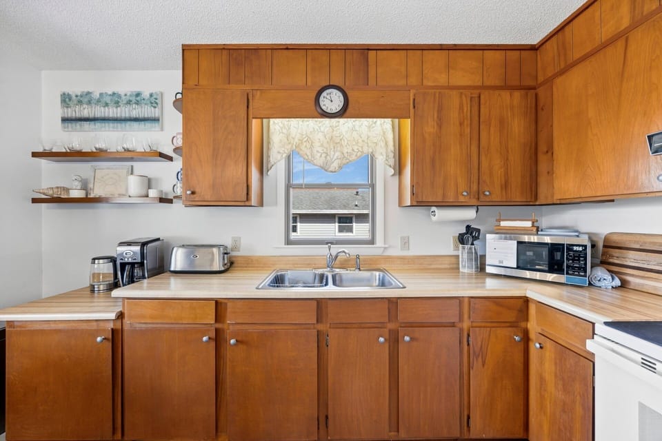 Kitchen: The well-equipped kitchen offers everything needed to prepare family meals while staying connected to the open living and dining spaces.