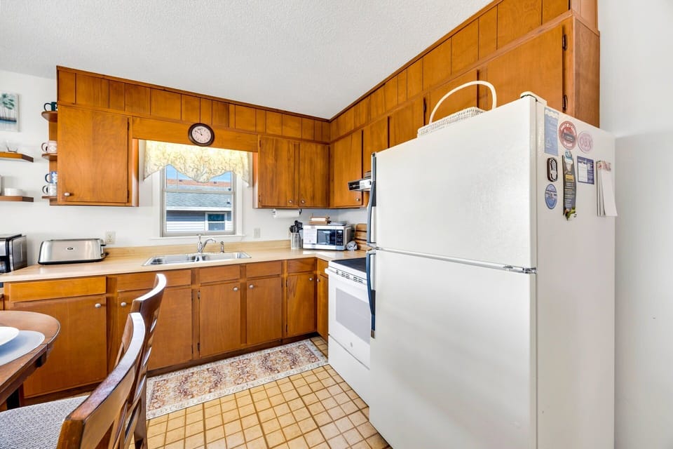 Kitchen: The well-equipped kitchen offers everything needed to prepare family meals while staying connected to the open living and dining spaces.