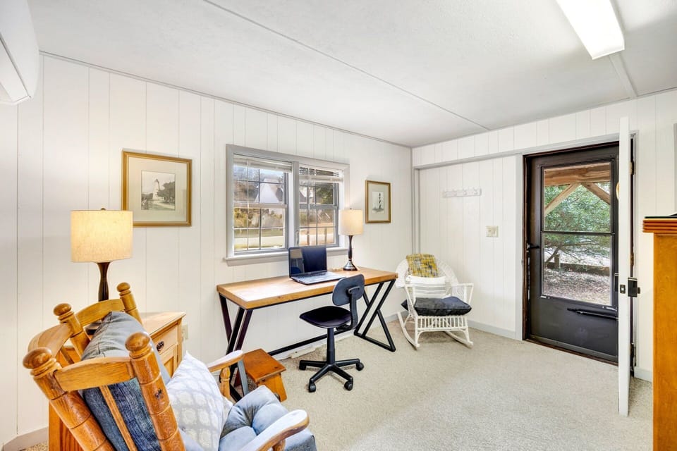 Den / Laundry Area: The dedicated desk area provides a convenient workspace for remote work, trip planning, or catching up on emails with a peaceful view nearby.