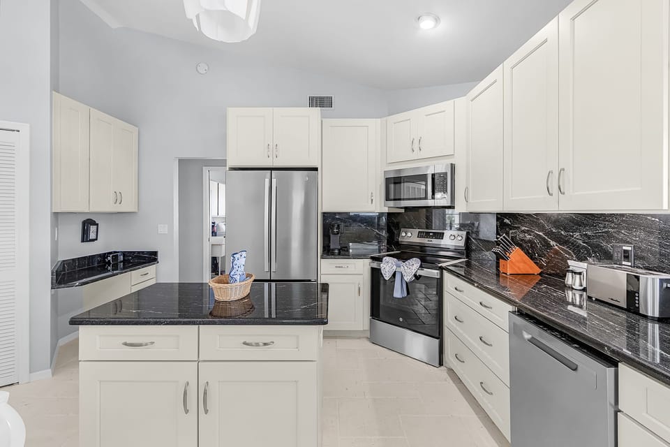 The fully-equipped kitchen has stainless steel appliances