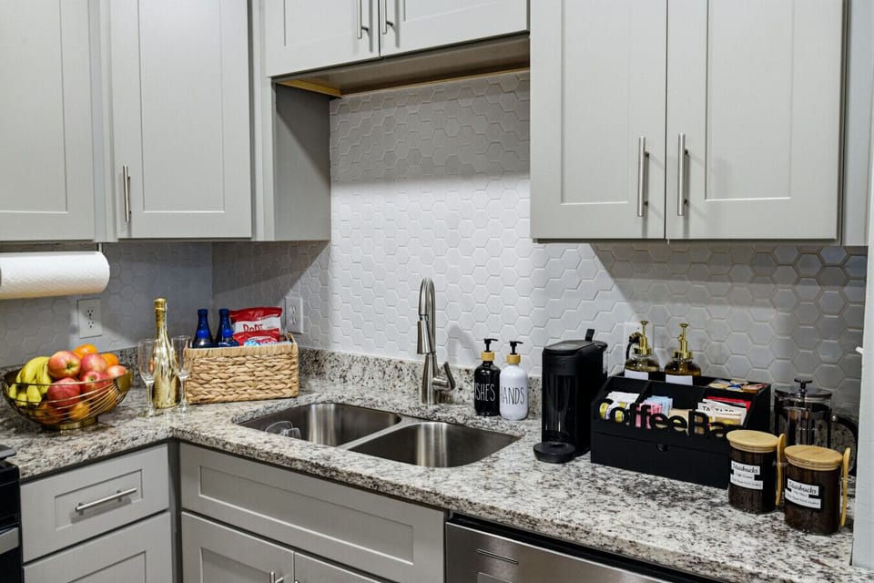 Spacious kitchen with stainless steel appliances, cooking essentials, and coffee & tea bar