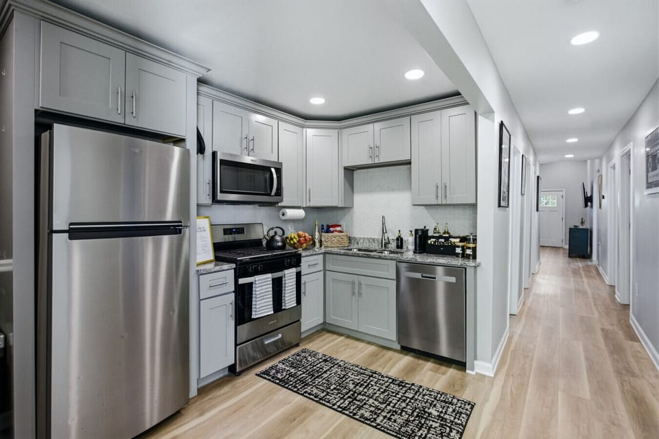Spacious kitchen with stainless steel appliances, cooking essentials, and coffee & tea bar