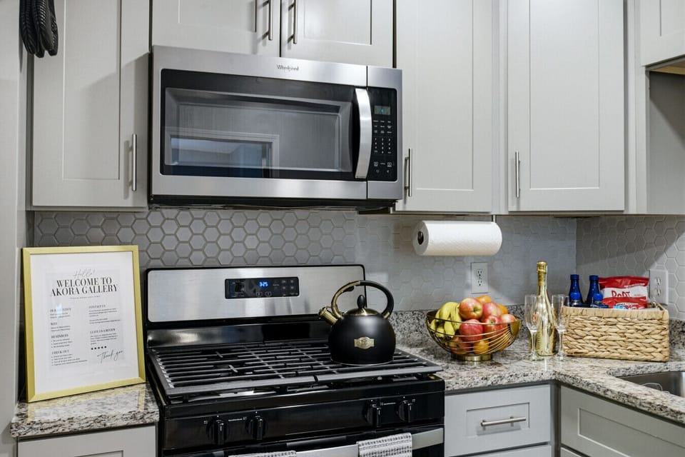 Spacious kitchen with stainless steel appliances, cooking essentials, and coffee & tea bar