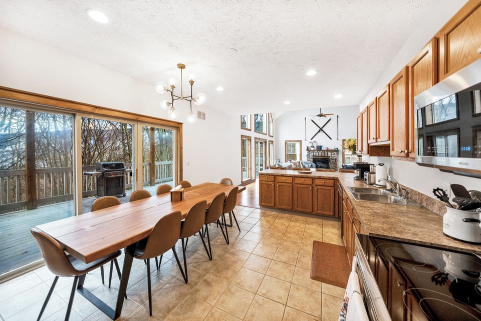 Direct view of the slopes out the kitchen windows. Grand live edge wood table with dinning for 12 plus 4 extra bar seats. Grill. Outdoor deck. 