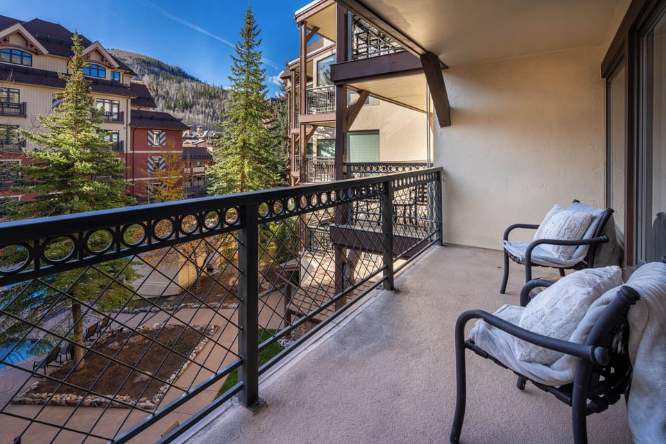 Step onto your private balcony with mountain views, where comfortable chairs await for morning coffee or evening relaxation.