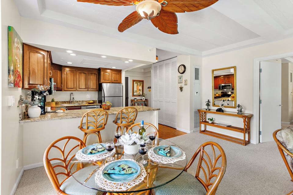 Your open-plan dining and kitchen space features tropical bamboo furnishings and granite countertops, perfect for gathering with family over home-cooked meals.