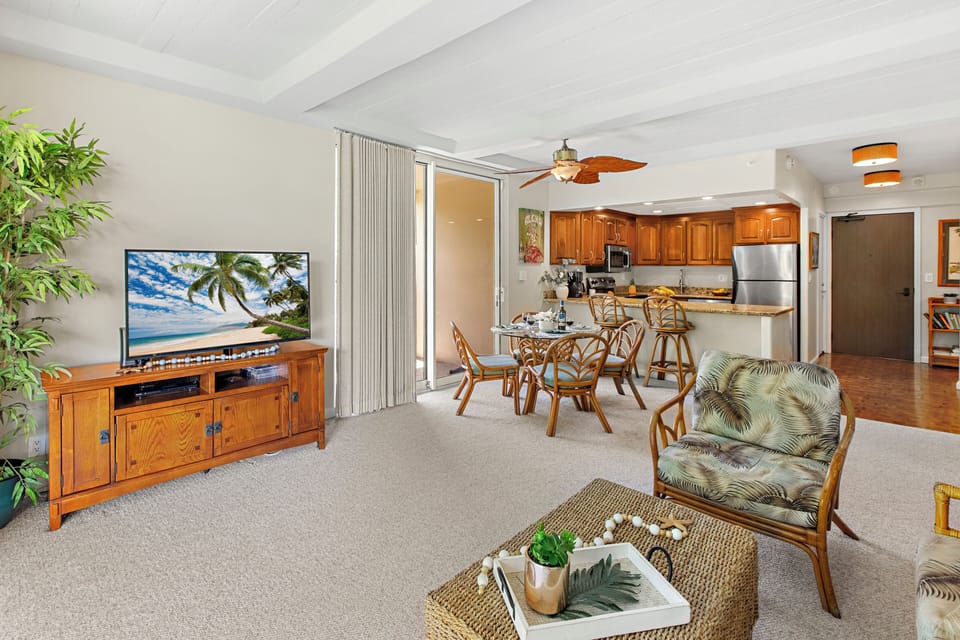 Unwind in your tropical-themed living space with bamboo furnishings, a full kitchen, and entertainment center for perfect island relaxation.