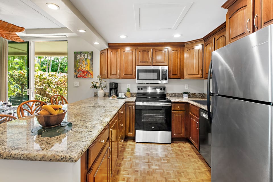 You'll love preparing meals in your fully equipped kitchen featuring granite countertops, stainless steel appliances, and garden views.