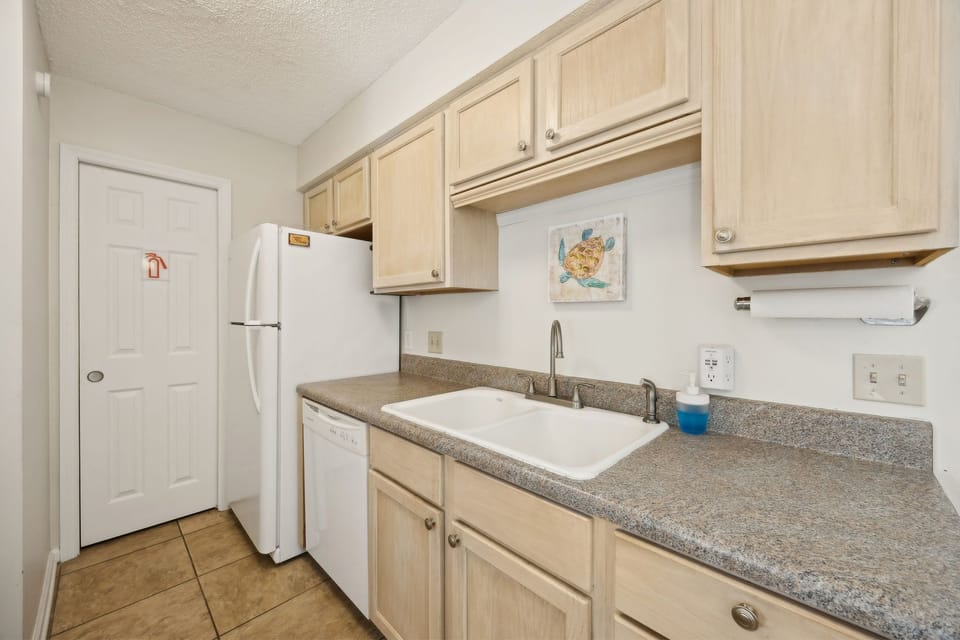 Your fully equipped kitchen awaits with warm wood cabinets, granite counters, and everything needed for memorable meals together.