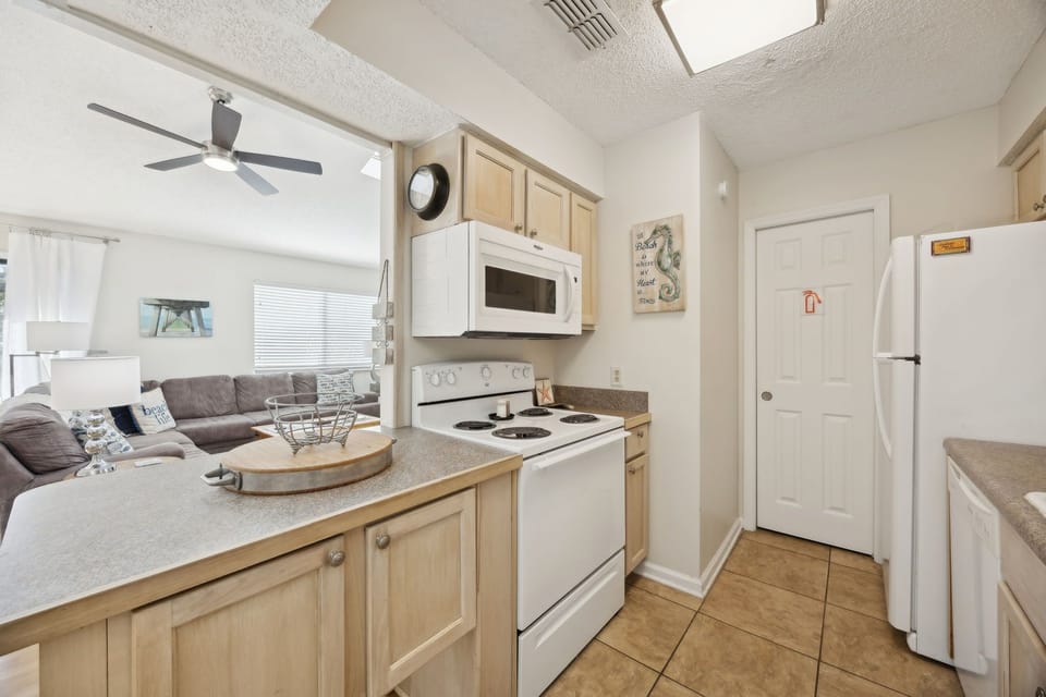 Your fully equipped kitchen opens to the living area, perfect for preparing meals while staying connected with family and friends.