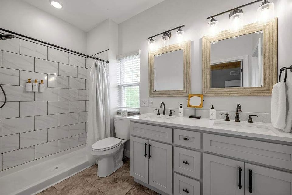 Start your mornings in this bright spa-inspired bathroom, where soft lighting, warm finishes, and a spacious double vanity make getting ready feel effortless.