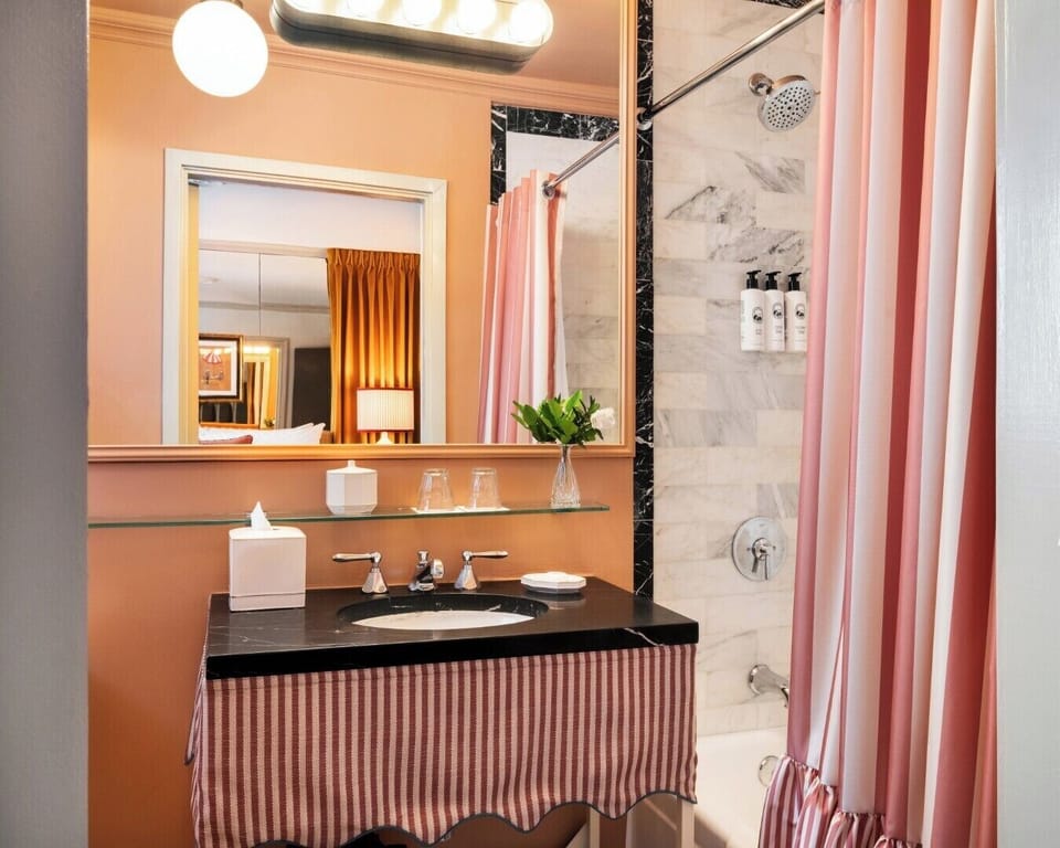 The Deluxe King | Bathroom | Combined shower/tub, designer toiletries, hair dryer, bathrobes