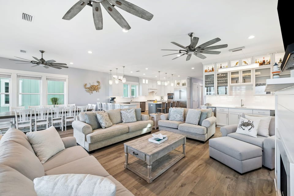 Unwind in your spacious open-concept living area with coastal vibes, plush seating, and a gourmet kitchen ready for memorable meals together.