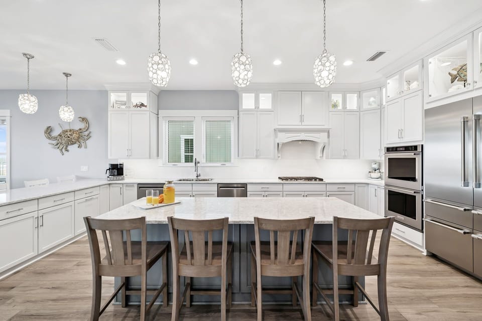 Your gourmet kitchen awaits with marble countertops, stainless steel appliances, and a spacious island perfect for morning coffee or evening gatherings.