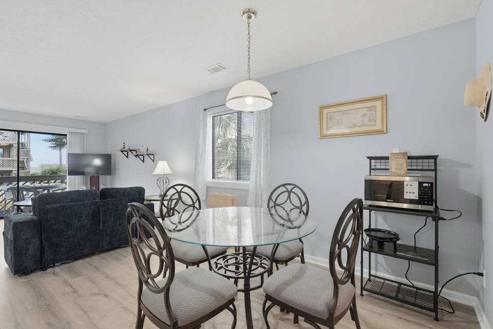 Gather around your elegant glass dining table while enjoying the bright, airy atmosphere of this beautifully appointed space.