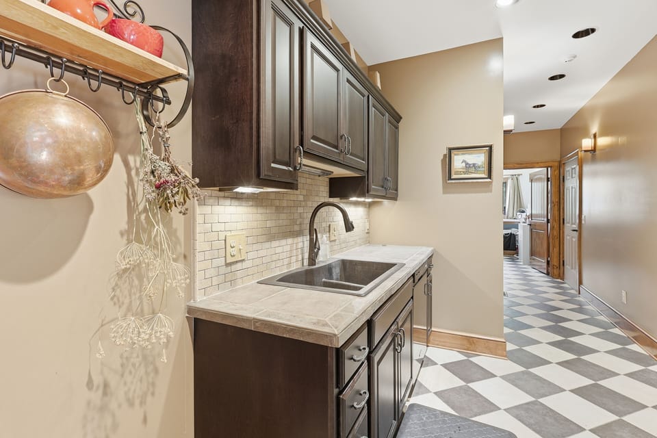 This elegant scullery-style prep space adds discreet luxury to your stay. Ideal for hosting, it allows meals to flow beautifully while keeping the main kitchen pristine and serene.