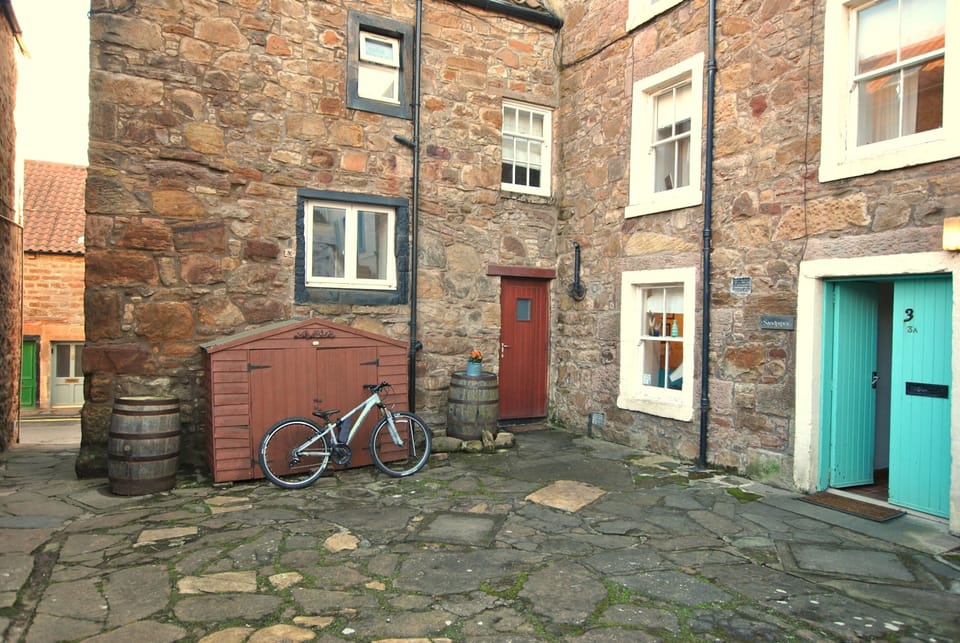 The quiet lane leads from the Coastal Path to the courtyard area