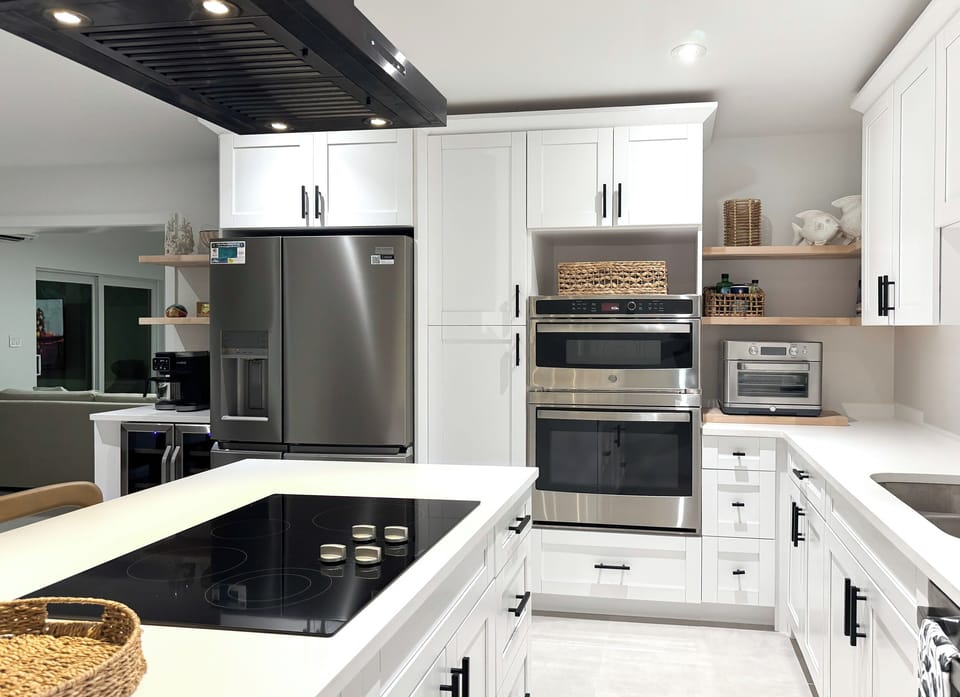 Kitchen equipped with stovetop, microwave, oven, refrigerator/freezer