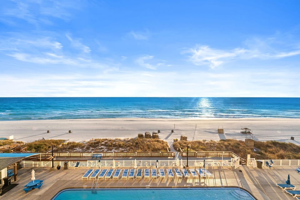 Your view from the balcony looks straight down to one of three pools and across to the beach and the sea.