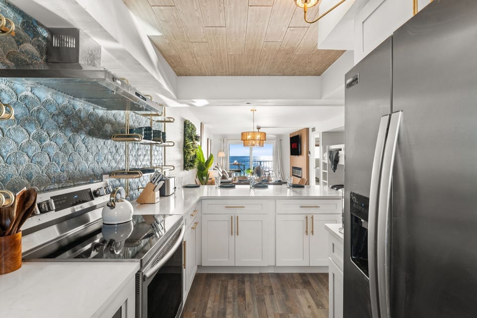 From the fully stocked kitchen look out across to your friends and family to the glistening sea