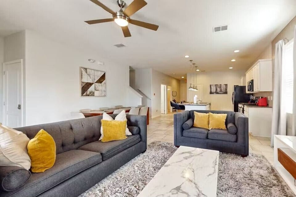 View of living room and kitchen from sliding doors that open to pool and lanai.