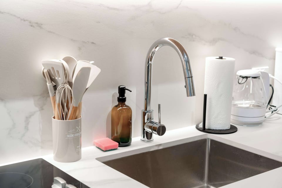 A deep, modern sink and ample counter space make post-dinner cleanup a breeze.
