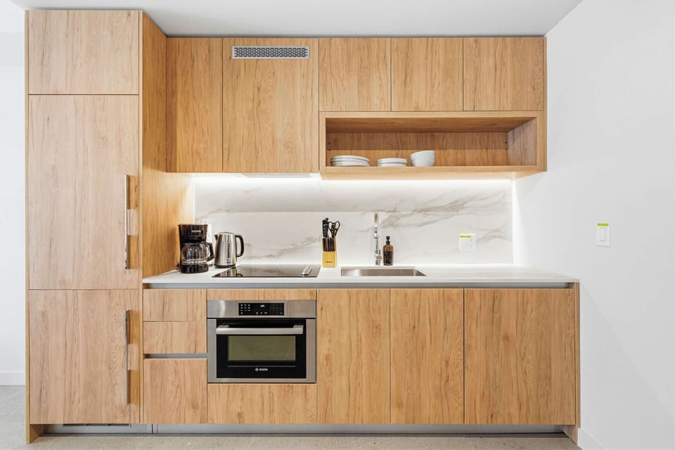 Enjoy a sleek, fully stocked kitchen with high-end finishes and a complete set of utensils, perfect for everything from quick snacks to full dinners