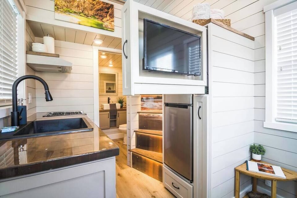 The kitchen is fully equipped with a refrigerator, freezer, microwave, stove and oven, and sink with hot/cold water. Enjoy coffee from the coffee maker, with cookware, dishes, utensils, and plenty of storage cabinets to keep everything organized.