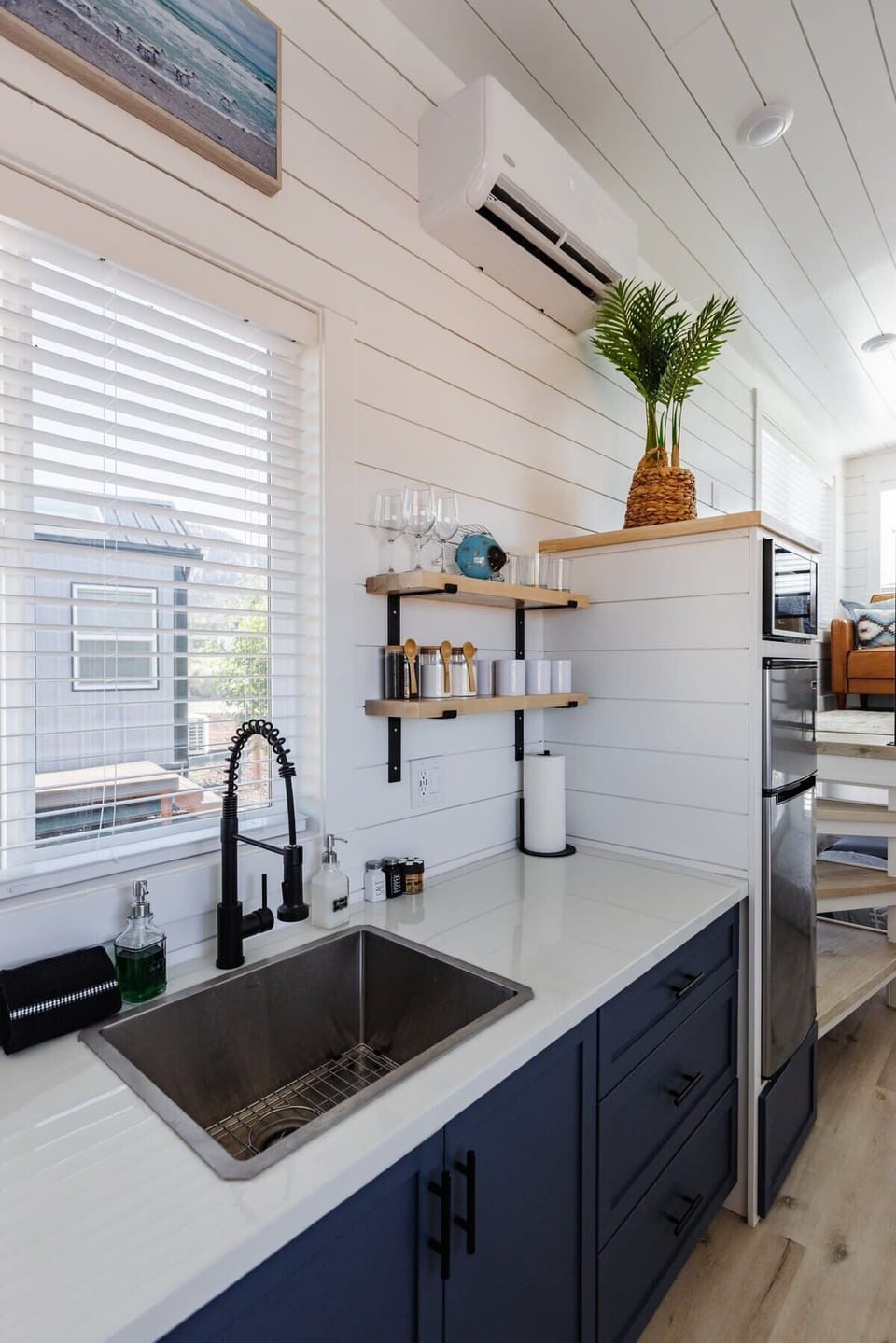 The kitchen is fully equipped with a refrigerator, freezer, microwave, cooktop, and sink with hot/cold water. Enjoy coffee from the coffee maker, with cookware, dishes, utensils, and plenty of storage cabinets to keep everything organized.