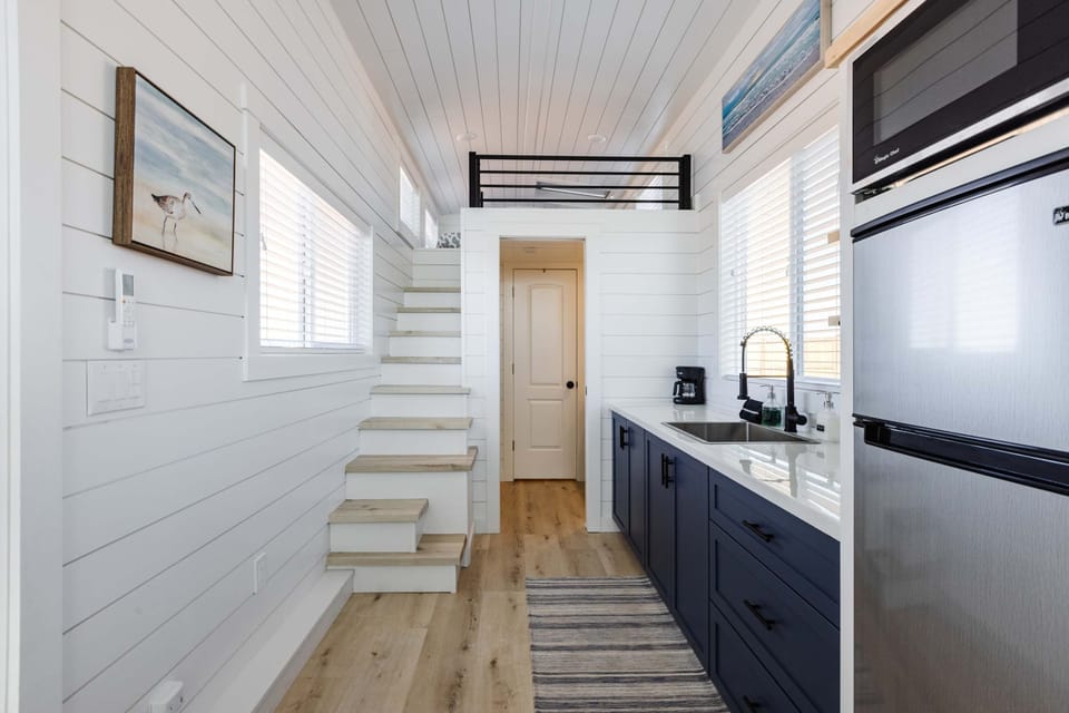 Stainless steel appliances, open shelving, and thoughtful storage maximize space while providing everything needed to prepare meals during your Southern Utah adventure.