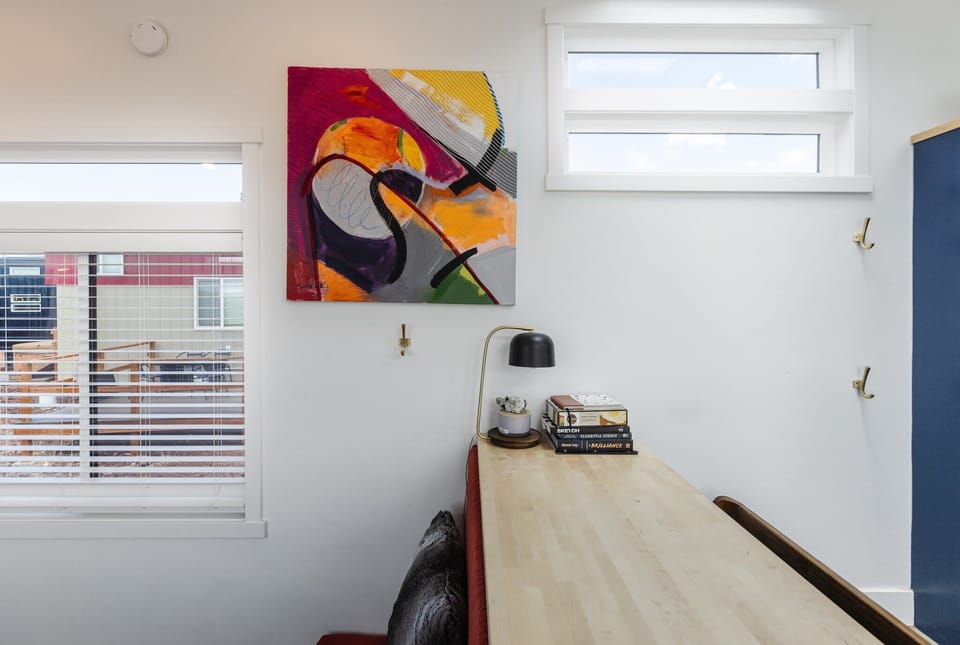 Functional bar-height table provides a convenient spot for dining, remote work, or trip planning. Large windows bring in natural light and views of the surrounding community.