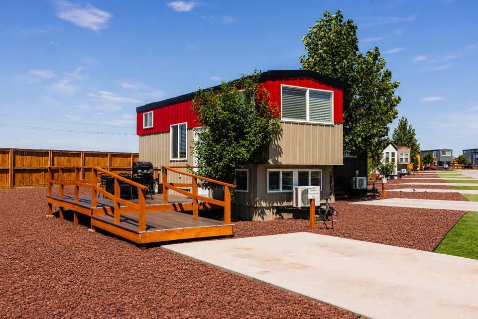 Arcadia tiny home near Zion National Park featuring an outdoor deck with BBQ, convenient parking in front, and a bright Southern Utah setting.