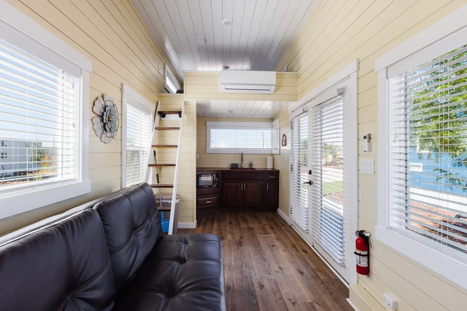 Open-concept layout connecting the living room and kitchen, with large windows and plenty of natural light. A welcoming space to unwind, enjoy a movie, or plan your next Southern Utah adventure.